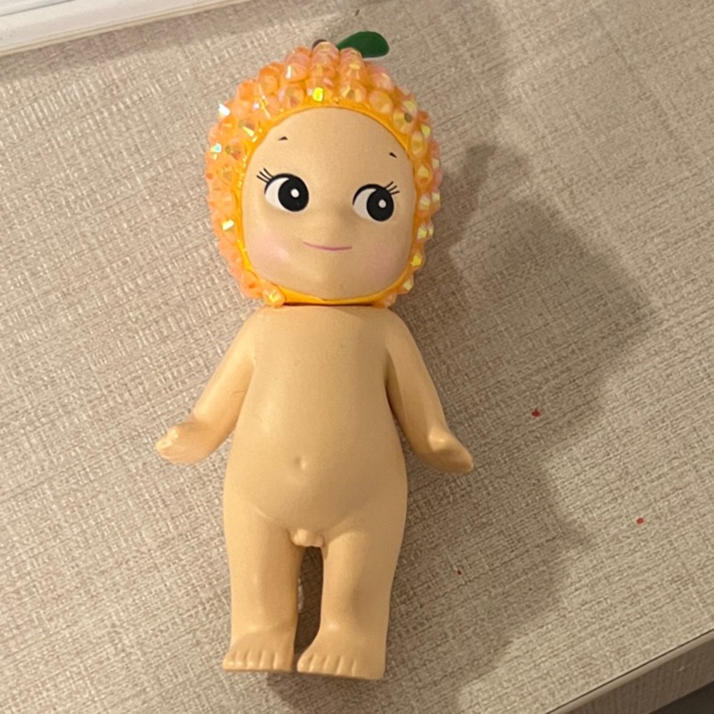 Cute Orange-Themed Doll with Leaf Accent